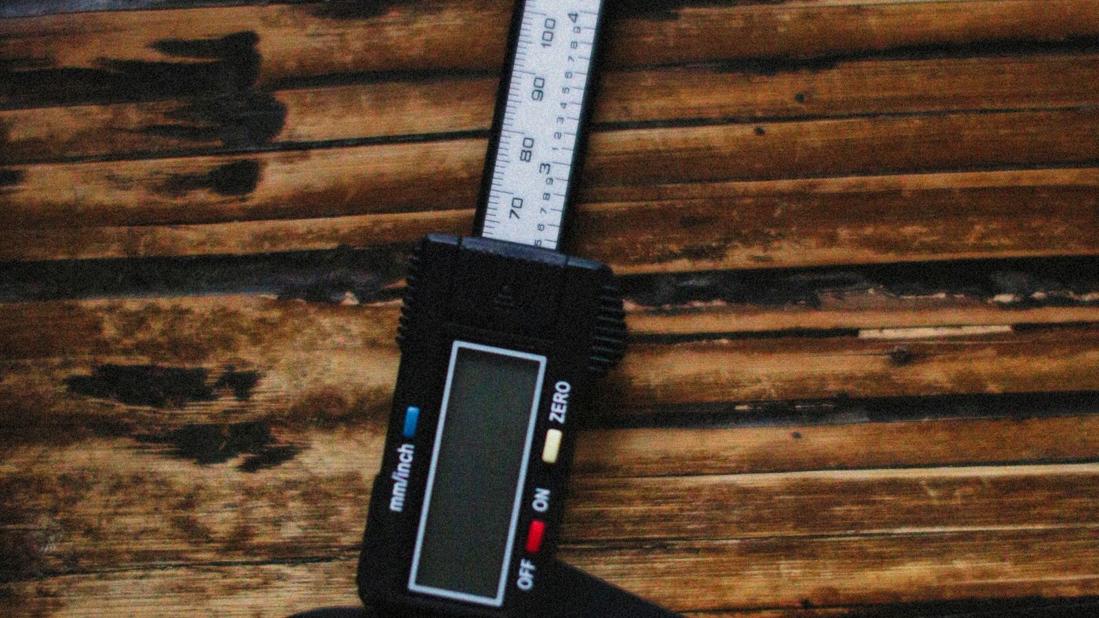 Digital caliper resting on a wooden surface