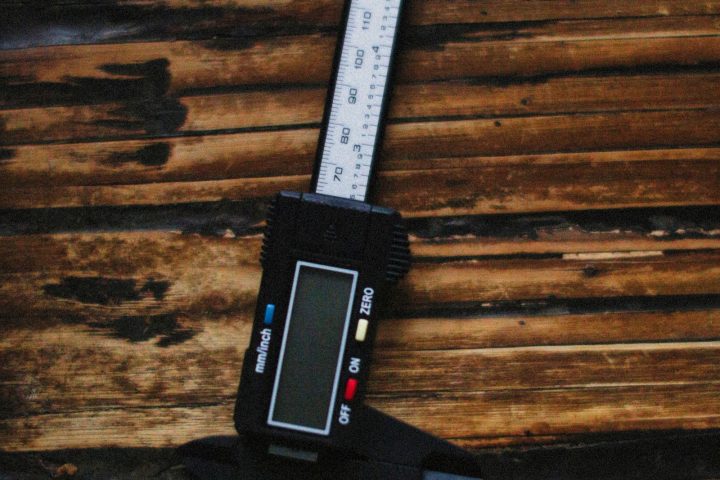 Digital caliper resting on a wooden surface