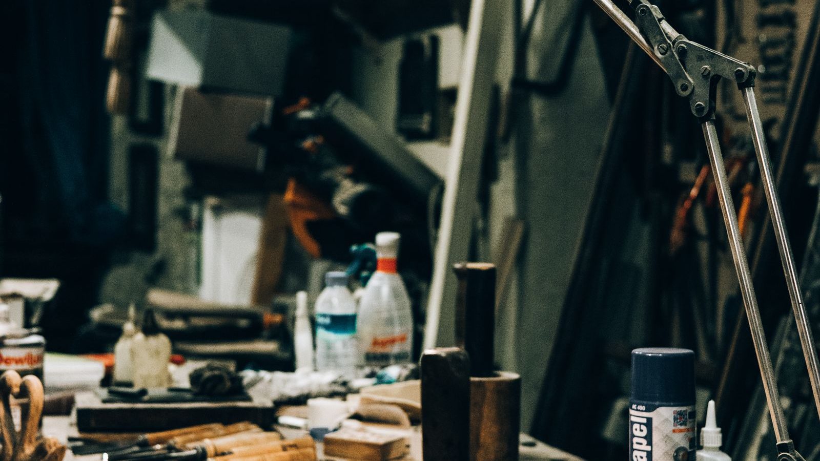 Warmly lit workshop with tools arranged under a lamp