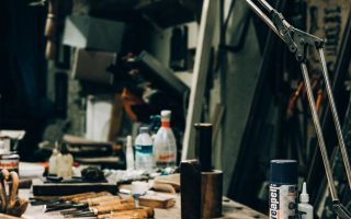 Warmly lit workshop with tools arranged under a lamp