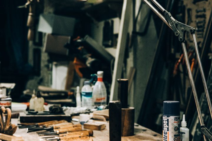 Warmly lit workshop with tools arranged under a lamp