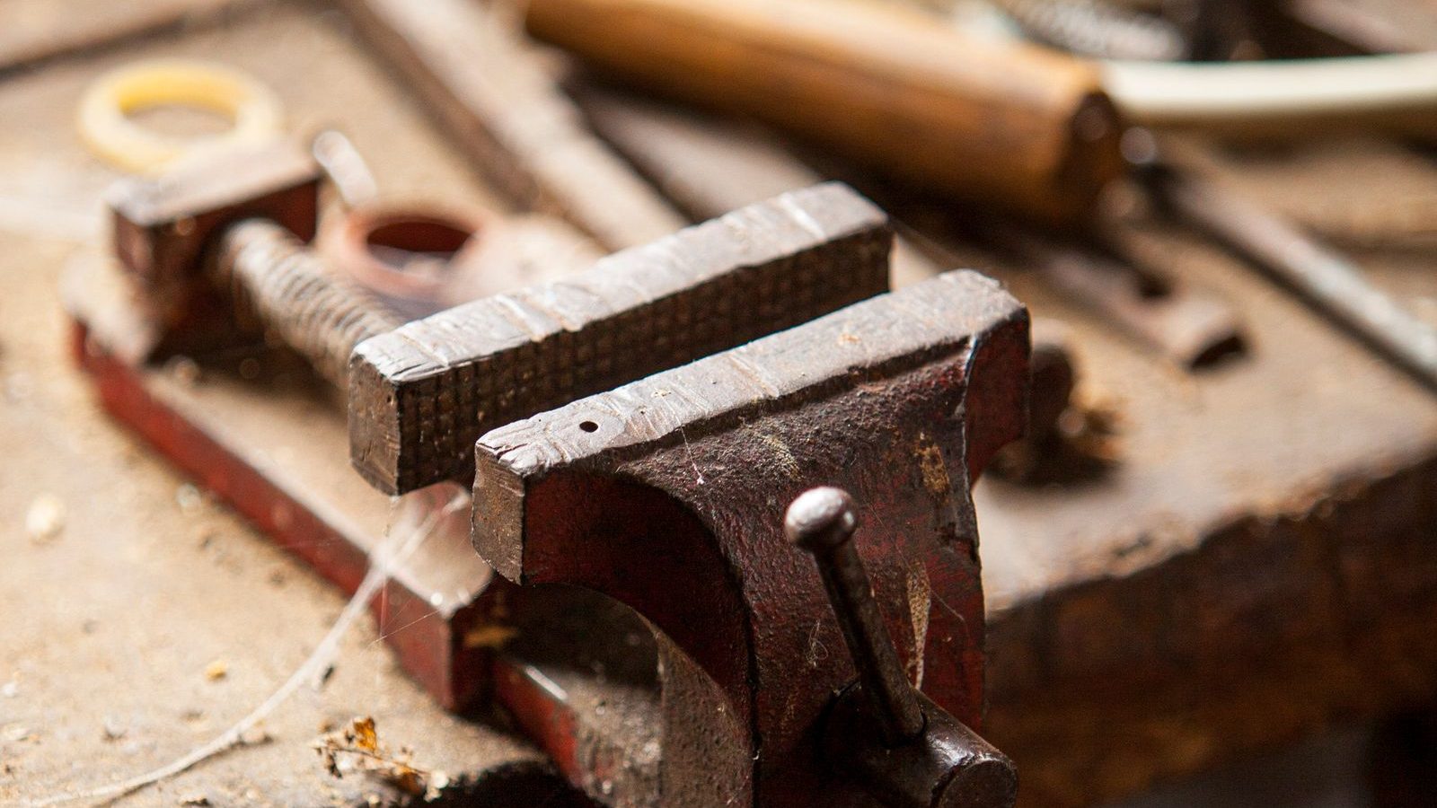Bench vise mounted on a wooden workbench