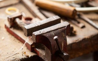 Bench vise mounted on a wooden workbench